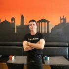 Artist, and Short Black barista, Robin Stock stands before his mural of silhouettes of Oamaru's...
