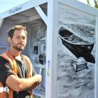 Artist Daniel Mead was  brightening up  a bus shelter on Brighton Rd on Friday. Photo by Linda...