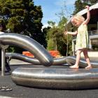 Artist Julia Morison watches Imogen Bailey (3), of Dunedin, playing on the flexible worm after...