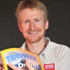 Aspiring Adventures co-founder Steve Wilson, with a copy of National Geographic Traveler magazine...