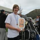 Aston Brookes shows off the goaltender award he won at the world under-20 third division ice...