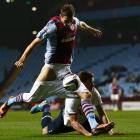 Aston Villa striker Nicklas Helenius shoots for goal despite having his shorts pulled down by...