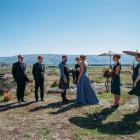 At the wedding ceremony in Middlemarch are (from left) groomsmen Scott Maddox and Dylan Bushnell,...