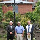 Attending a ceremony at Kavanagh College to lay a new plaque beneath the bronze crucifix made by ...