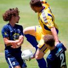 Auckland City FC's Albert Riera (left) and Simon Arms clash with Otago United's Victor Da Costa...