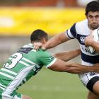 Auckland's Paul Williams looks to fend off the tackle of Manawatu's Aaron James in the Air New...