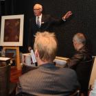 Auctioneer Derek Smith auctions <i>Nineteen Ninety</i> (far left), by Ralph Hotere, at the Otago...