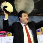 Auctioneer Jeremy Anderson collects bids on a sleeping cat tea cosy at Nga Maara Hall at Sacred...