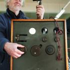 Auctioneer Kevin Hayward takes a closer look at a transmitter used to make  New Zealand's first...