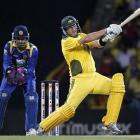 Australian batsman Shane Watson hits out as Sri Lankan wicketkeeper Kumar Sangakkara watches...