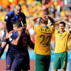 Australian players show their disappointment as Robin van Persie (9) of the Netherlands...