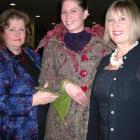 Winning WoolOn garment creator Donna Hansen (left), helps fit the creation "Wolf With The Red...