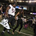 Baltimore Ravens' Jameel McClain (left) dances with Telemundo reporter Mirrella Grisales during...
