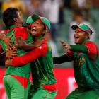 Bangladesh bowler Rubel Hossain (L) is congratulated by teammates after bowling England's Stuart...