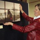 Bannockburn photographer Jan Moore adjusts one of her exhibits, titled Looking In/Looking Out:...