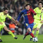Barcelona's Lionel Messi slaloms through Lyon's Jeremy Toulalan, left, and his teammate Cesar...
