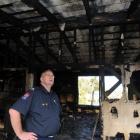 Barry Gibson inspects a Somerville St house burnt last week. Photo by Peter McIntosh.