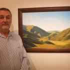 Barry Mackenzie with a painting of the Lindis Pass which is part of his exhibition at the...