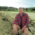 Barry Todd takes a break from lifting rocks druing construction of a dry stone wall near Duntroon...