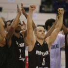 New Zealand's Michael Fitchett (centre) and his teammates celebrate a victory against Canada