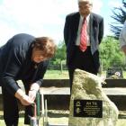 Beaumont resident Margaret Healy lights a candle of behalf of the Beaumont community at the...