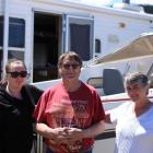 Beth, Bruce, and Raewyn Smith next to their boat and caravan at the Clyde Holiday and Sporting...