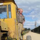 Bill Pile prepares to inspect his handiwork after fixing potholes on Steward Rd with his own...