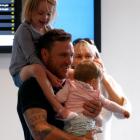 Black Caps captain Brendon McCullum holds his daughters after arriving at Auckland Airport today....