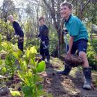 Blake Conroy (9, left), Liam Wilson (10, centre) and Devin Colston (10) plant trees at East...