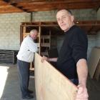 Blossom Festival event manager Martin McPherson (right) helps Neil McArthur, from the Men's Sheds...