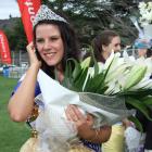 Blossom Festival Queen Ellie Trask (18) takes a congratulatory call after the crowning ceremony....