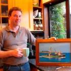 Bluff skipper Peter Leask (46) holds a photo of  Torea which now lies aground off Ruapuke Island....