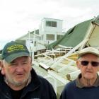 Bob Goodeve (left) and Dick Langford  in front of the wrecked  public stand last month. Photo by...
