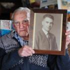 Bob Heenan with a photograph of his brother, Arthur, a Coastwatcher beheaded on Tarawa, in...