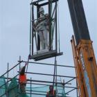 Off his perch . . . The statue of Trooper David Mickle Jack is lowered from the top of the Boer...