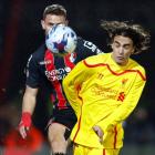 Bournemouth's Simon Francis (L) crosses the ball past Liverpool's Lazar Markovic during their...