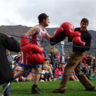 Boxing busker and professional clown Fraser Hooper (left), of Wellington, takes on Wanaka man...