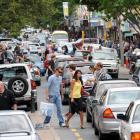 Boxing Day shoppers in Dunedin dodge traffic in George St yesterday. Photo by Stephen Jaquiery.