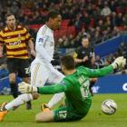 Bradford City's goalkeeper Matt Duke fouls Swansea City's Jonathan de Guzman for a penalty during...