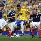 Brazil's Neymar, 2nd right, keeps the ball from Scotland's Scott Brown, right, and James Morrison...
