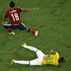 Brazil's Neymar holds his back after being challenged by Colombia's Camilo Zuniga during their...