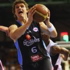 Breakers shooting guard Kirk Penney (above left) drives to the basket during the round seven NBL...