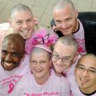 Breast-cancer survivor Sandy Wilson (centre) flanked by head-shave volunteers (clockwise, from...