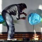 Brendan Wong, of Dunedin, adds touches to a fish lantern in North Dunedin on Saturday. Photo by...