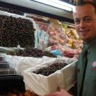 Brent Omond of Alexandra New World loads Central Otago cherries into the supermarket's fruit and...