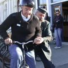 Brian Coubrough, from Melbourne, is helped on to a penny farthing by Oamaru Victorian Town at...