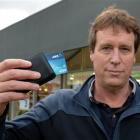 Brian McKay, of Dunedin, holds the Visa payWave credit card with which he  unintentionally paid...