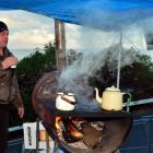 Brighton resident Neil Bush holds  a cup of a tea yesterday while  protesting against the...