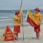 Brighton volunteer lifeguards Alex Sutherland (left) and Daniel McKay prepare flags for today's...