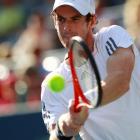 Britain's Andy Murray hits a return to Alex Bogomolov Jr. of Russia during their men's singles...